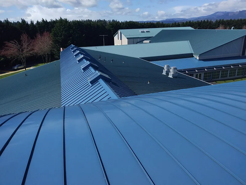 Blue metal roof over large commercial building