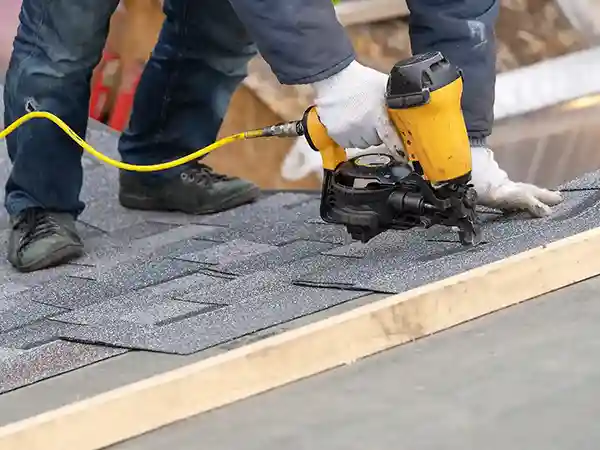 Roofer installing new shingles