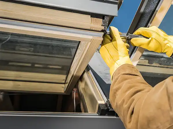 Worker installing new skylights